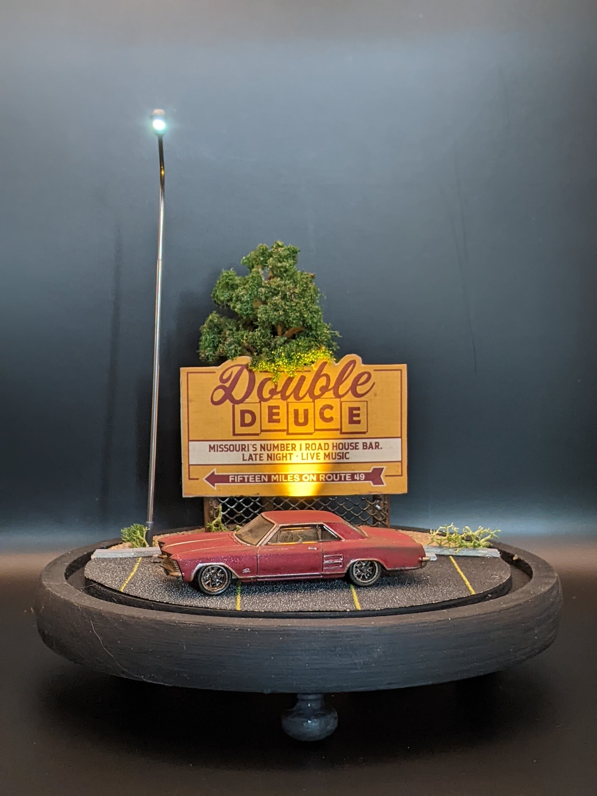 Handmade movie diorama lamp displayed under a glass bell jar with atmospheric lighting.
