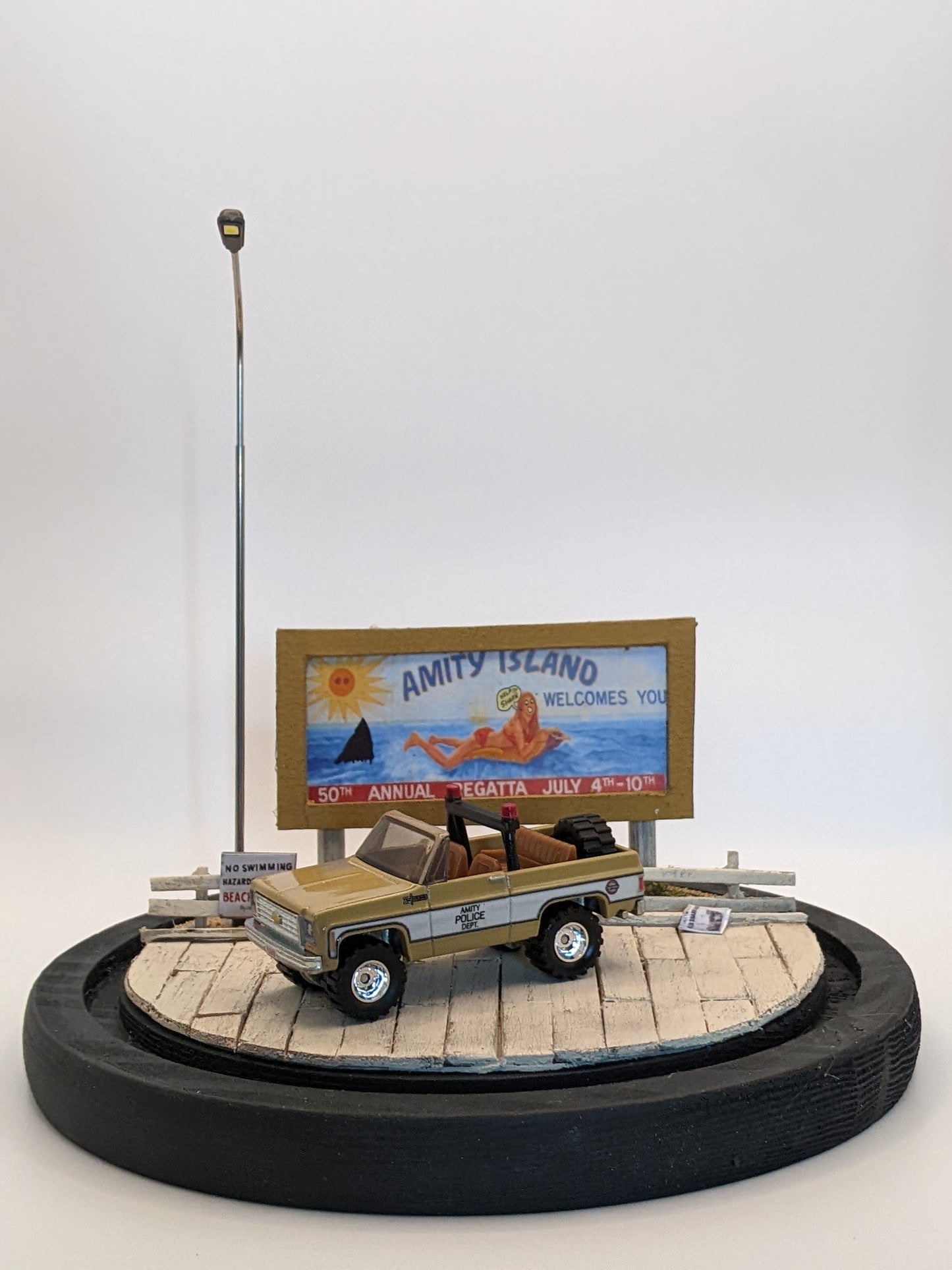 Handmade Jaws diorama lamp jar featuring Amity Island boardwalk, sheriff’s car, and billboard.