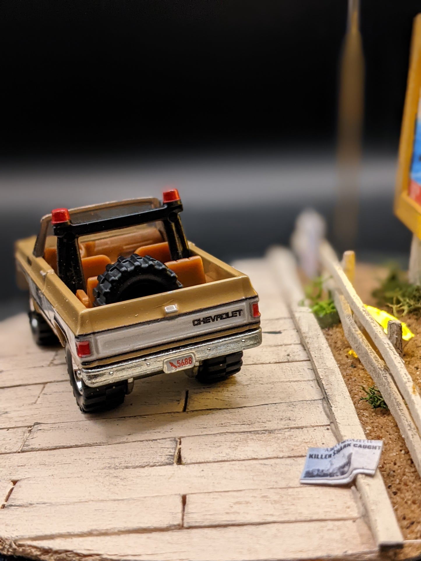Close-up of back of 1:64 scale sheriff’s car in handmade movie diorama lamp.