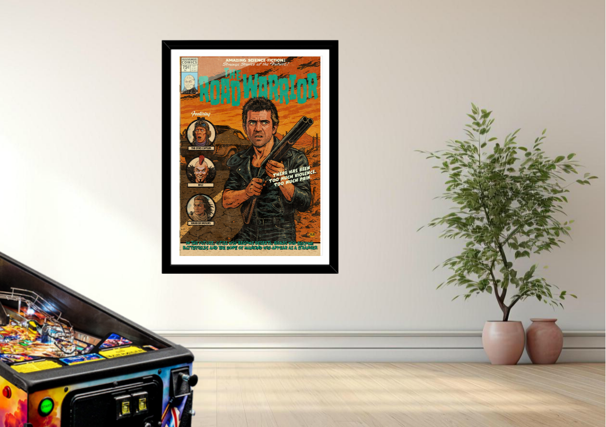 Framed movie poster of Mad Max on a wall next to a pinball machine and plants.
